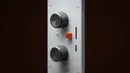 A close up of a control panel on a wall.