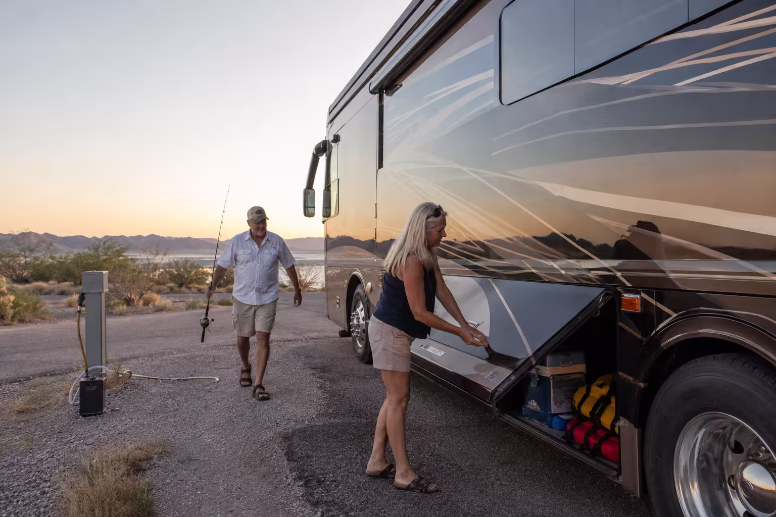 Couple loading fishing gear into a luxury RV at Elephant Butte