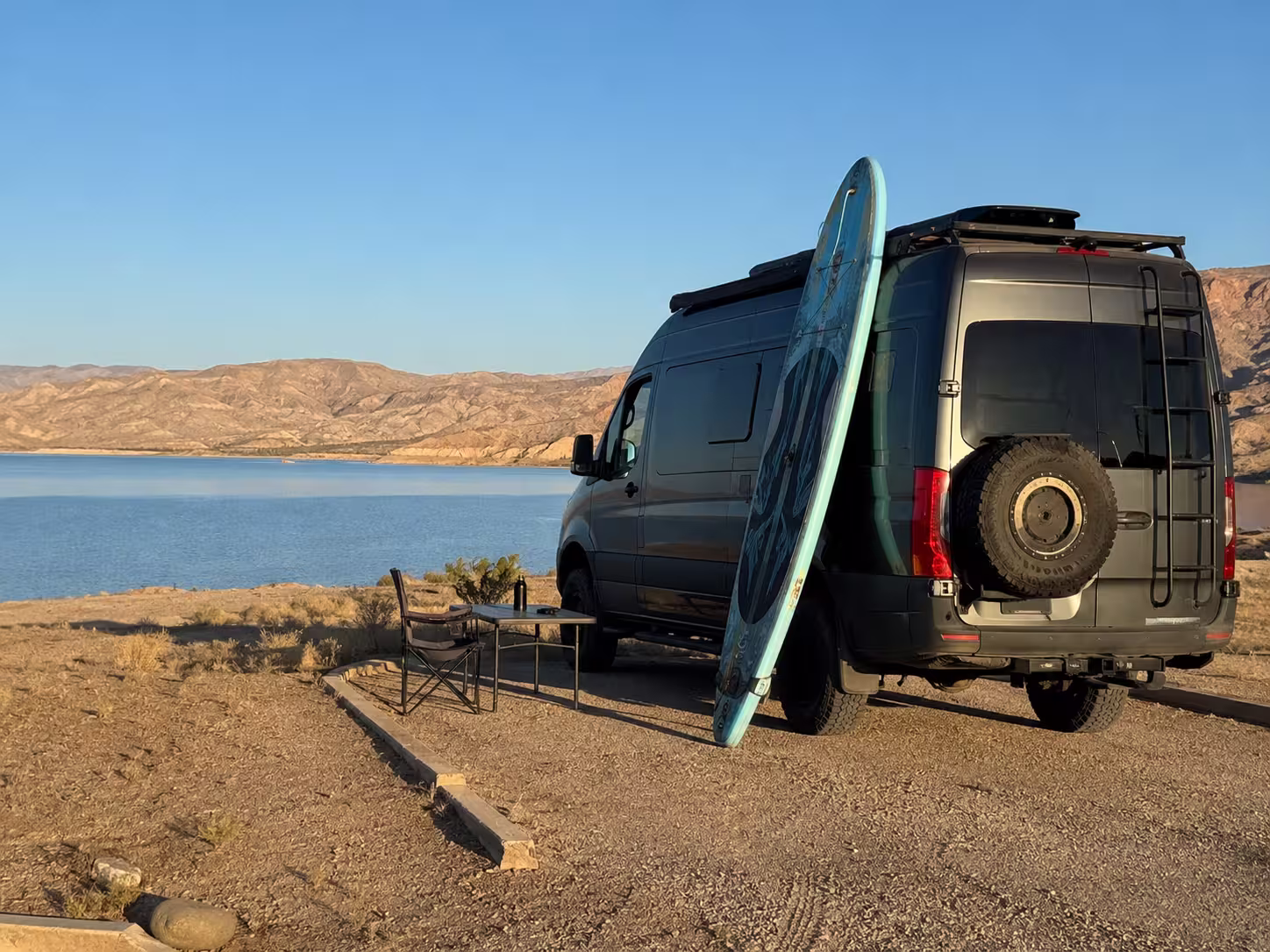 Camper van at a lakeside campsite pad in Elephant Butte