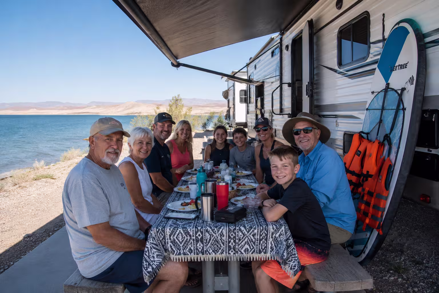 Group camping beside a large RV rental at Elephant Butte Lake