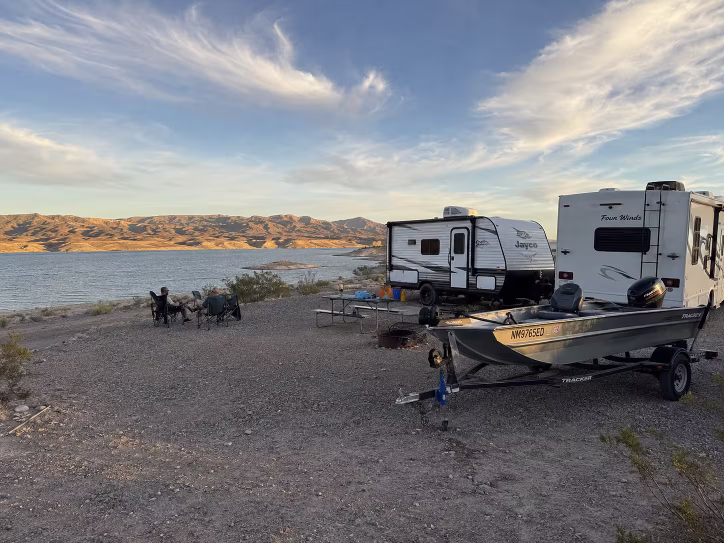 Campers and boat trailer at a lakeside RV site in Elephant Butte