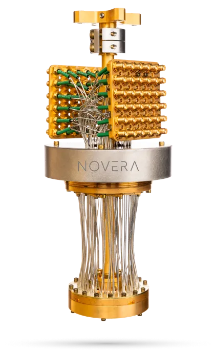 Novera quantum computer component with gold and green connectors and numerous wires.