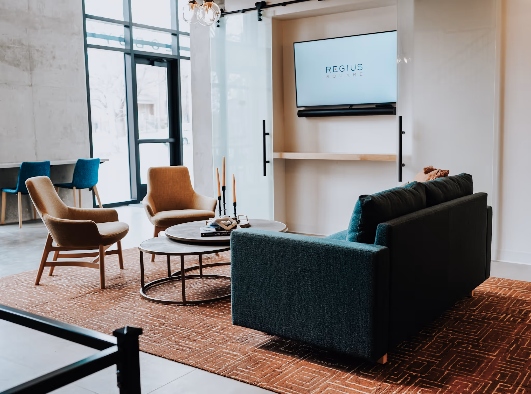 Common seating area with sofa chairs, coffee table, and tv