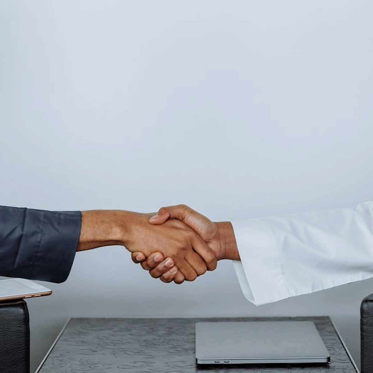 Handshake between two professionals representing an agreement or partnership