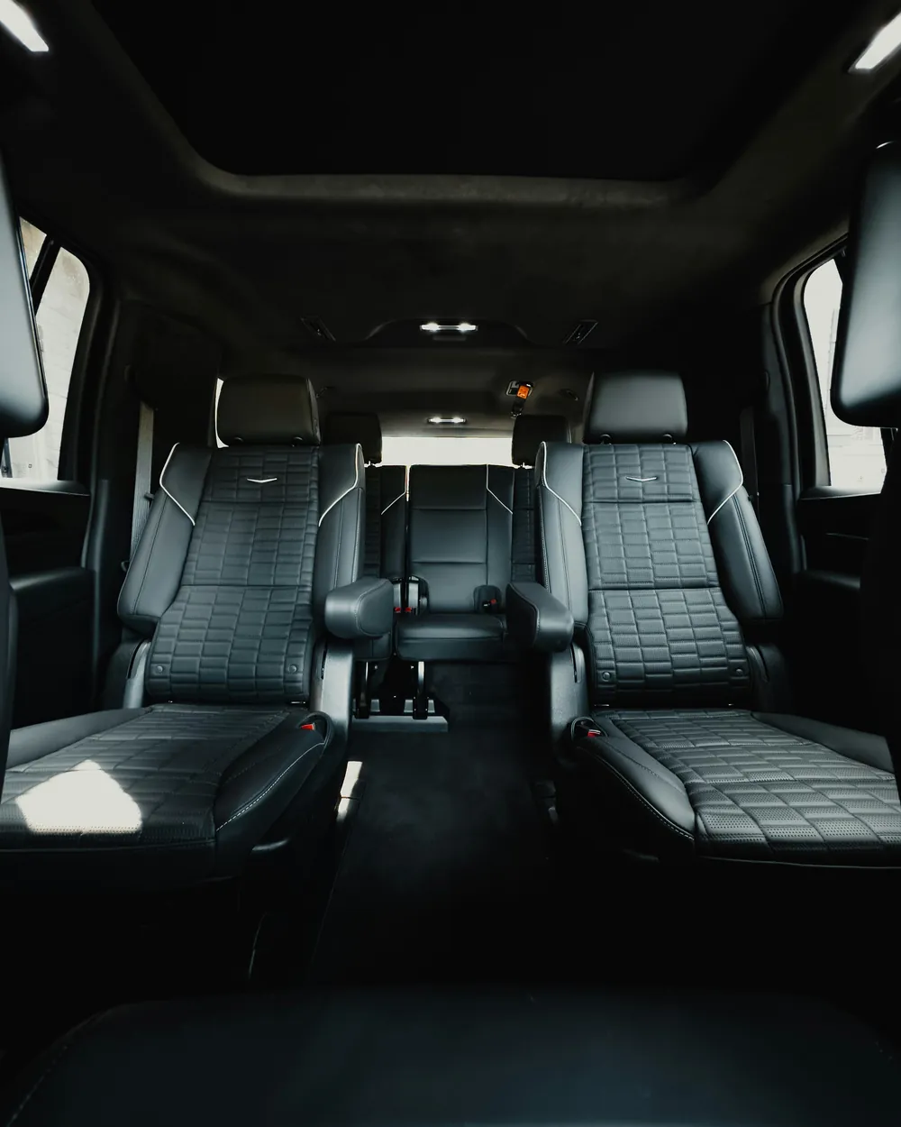 Clean black leather second-row captain seats inside a full-size SUV