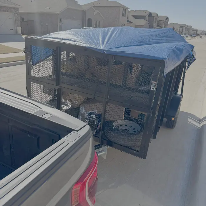 Tarped trailer load ready to haul from a DFW property
