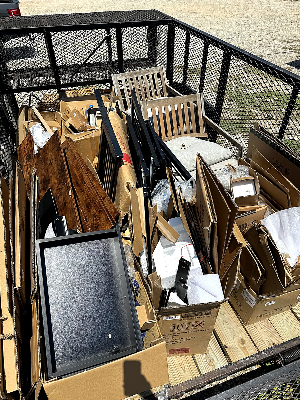 Trailer loaded with lumber, drywall and construction debris from a DFW remodel project