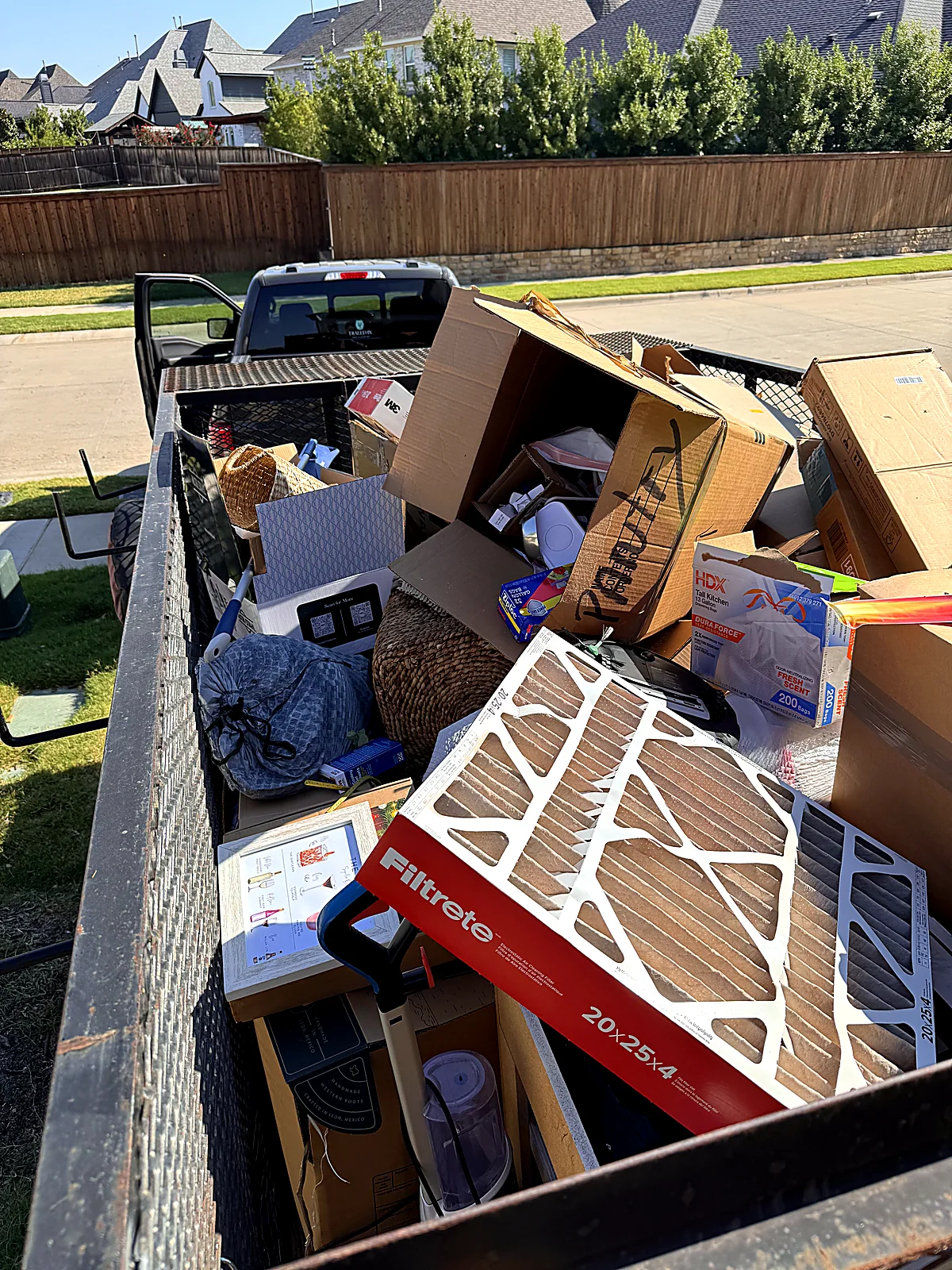 Trailer loaded with household furniture and boxes during a self-load junk removal job in DFW