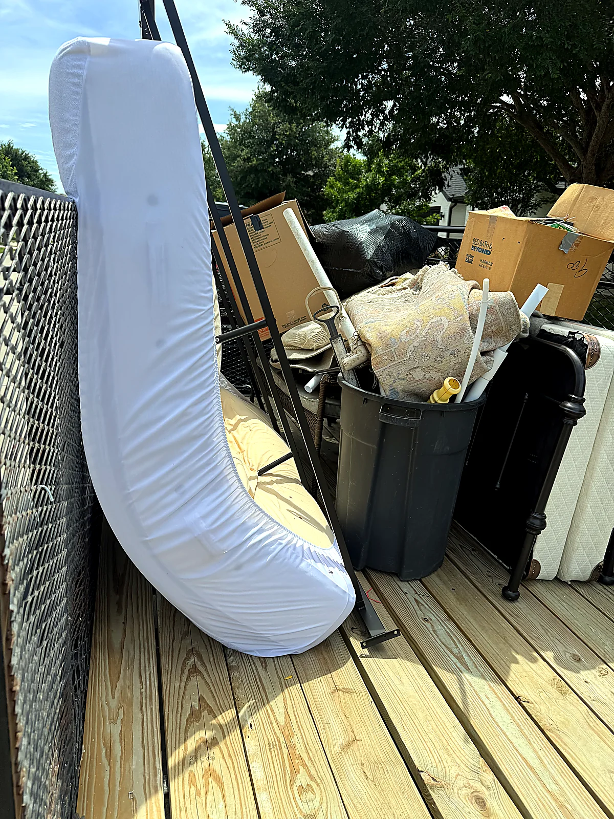 Old mattress and household items set out for junk removal pickup in the Dallas-Fort Worth area
