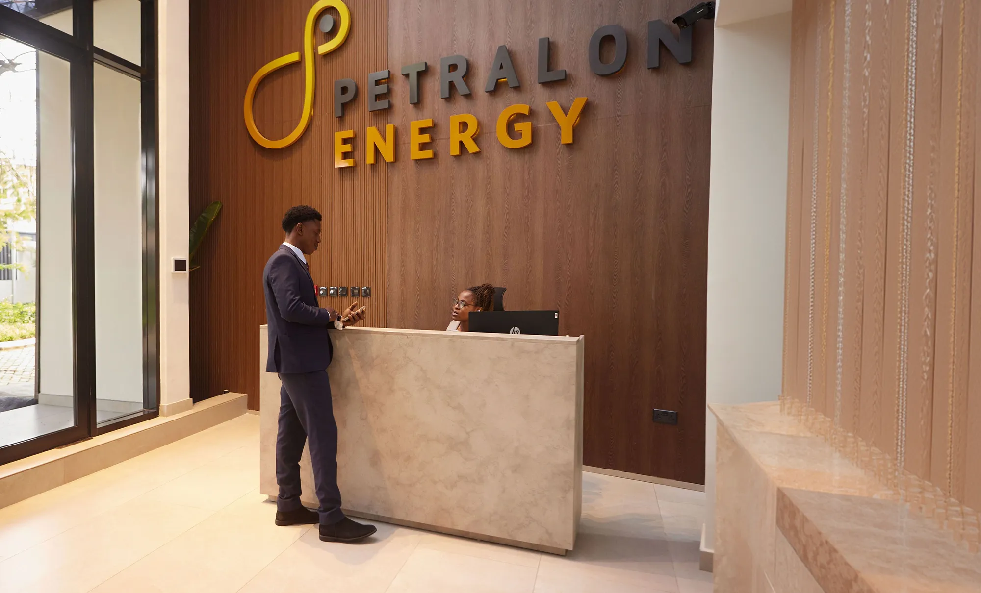 An image of an office desk showing an african man behind the desk