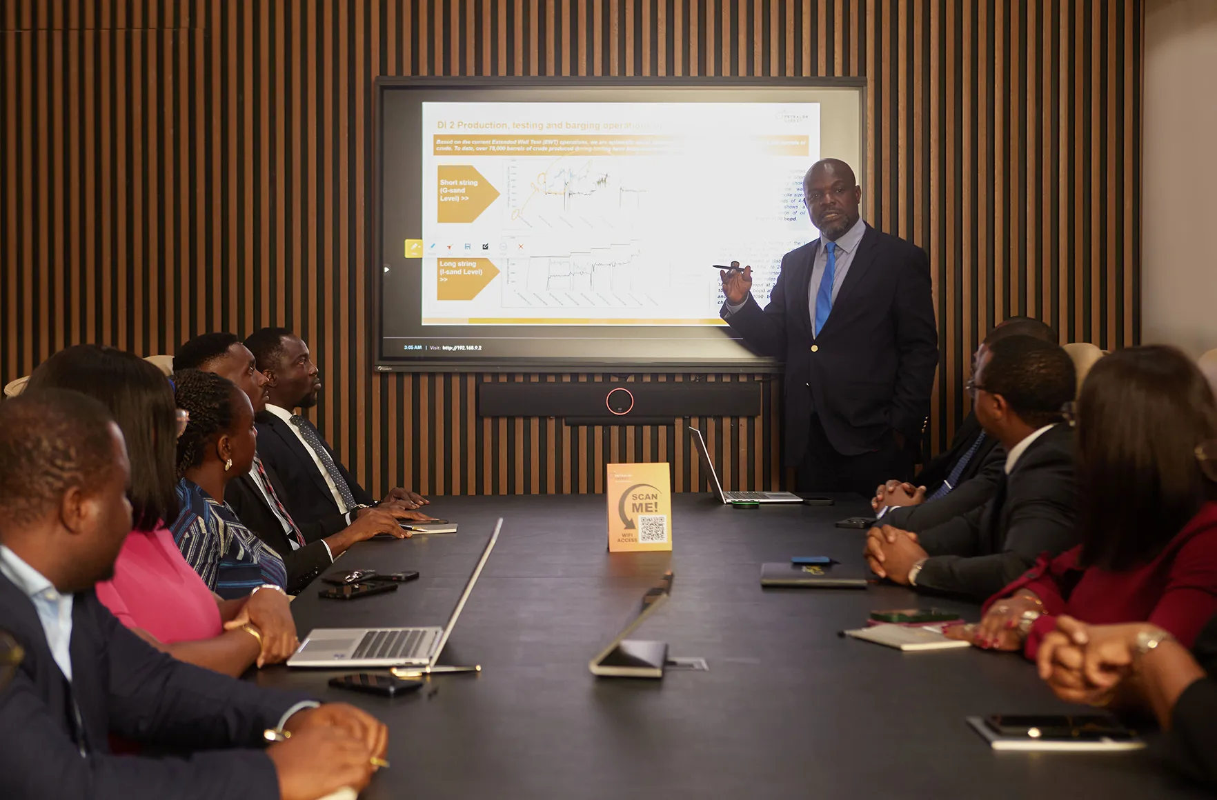Image featuring A woman 2 Men and another woman all sitting across a table in an office meeting