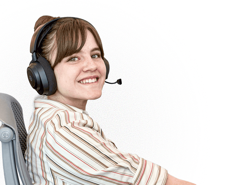 Smiling woman wearing a striped shirt and black headset sitting in a chair looking at camera.