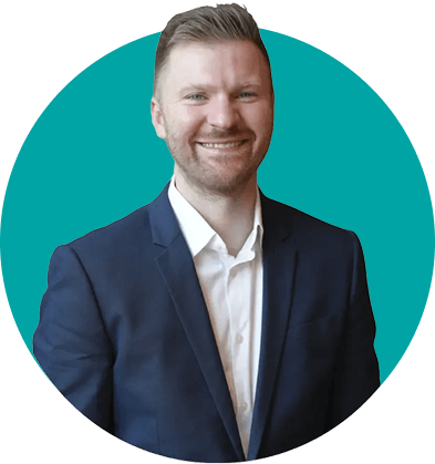 Smiling man with short light brown hair wearing a dark blue suit and white shirt against a teal circular background.