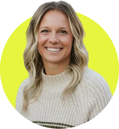 Smiling woman with wavy blonde hair wearing a light knitted sweater against a lime green circular background. Employer Medicare Benefits & Transition Support | Exact Benefits