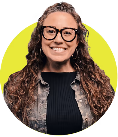 Smiling woman with long curly hair, wearing large glasses, hoop earrings, a camo jacket, and a black top against a lime green circular background.