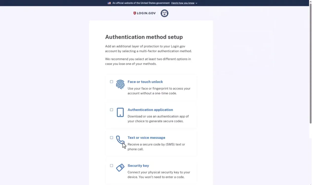 Login.gov page for setting up authentication methods recommends adding multi-factor authentication with options: Face or touch unlock using fingerprint or face without a one-time code; Authentication application to generate secure codes; Text or voice message for receiving codes via SMS or phone call; Security key device connection with no code entry needed.