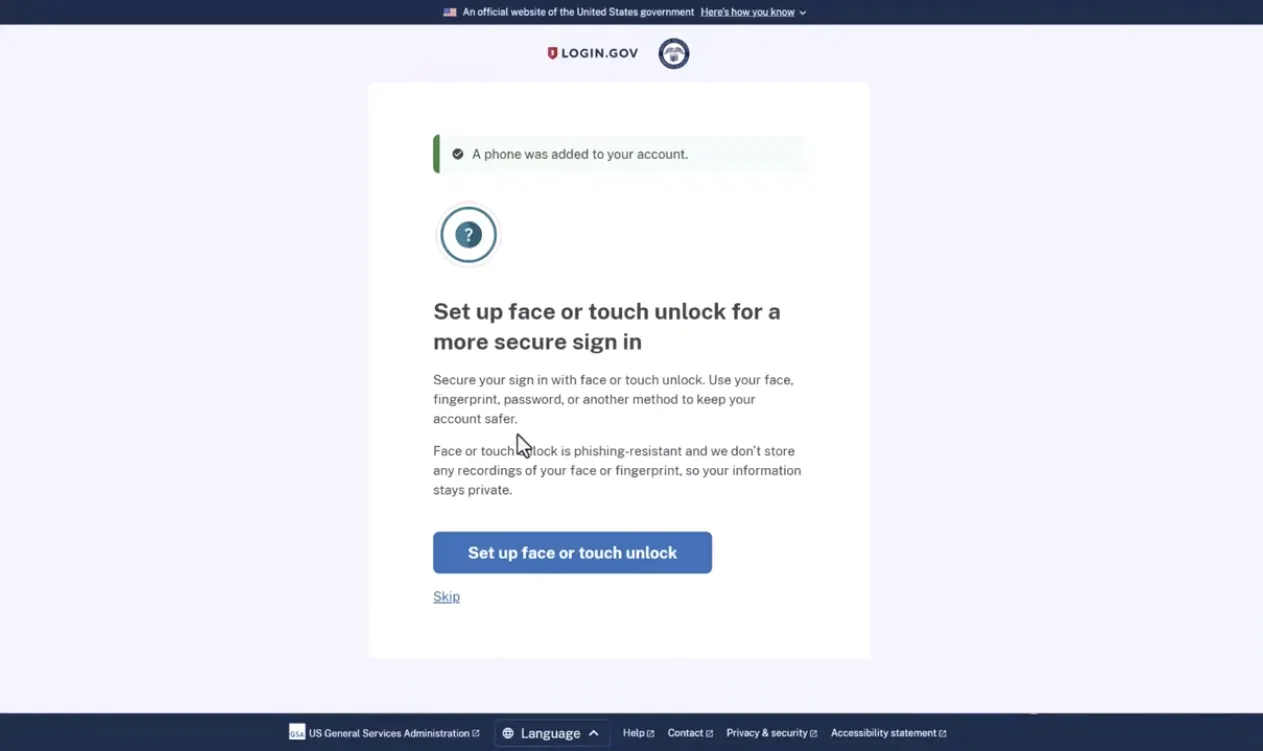 Login.gov webpage showing a confirmation that a phone was added to the account and a prompt to set up face or touch unlock for a more secure sign-in with options to set up or skip.