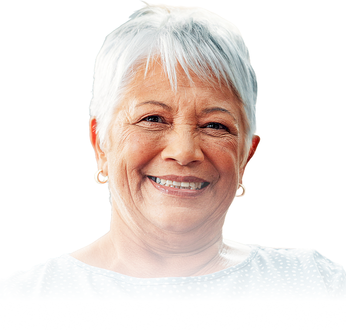 Smiling elderly woman with short white hair, wearing small hoop earrings and a light-colored top with a subtle dotted pattern, against a white background.