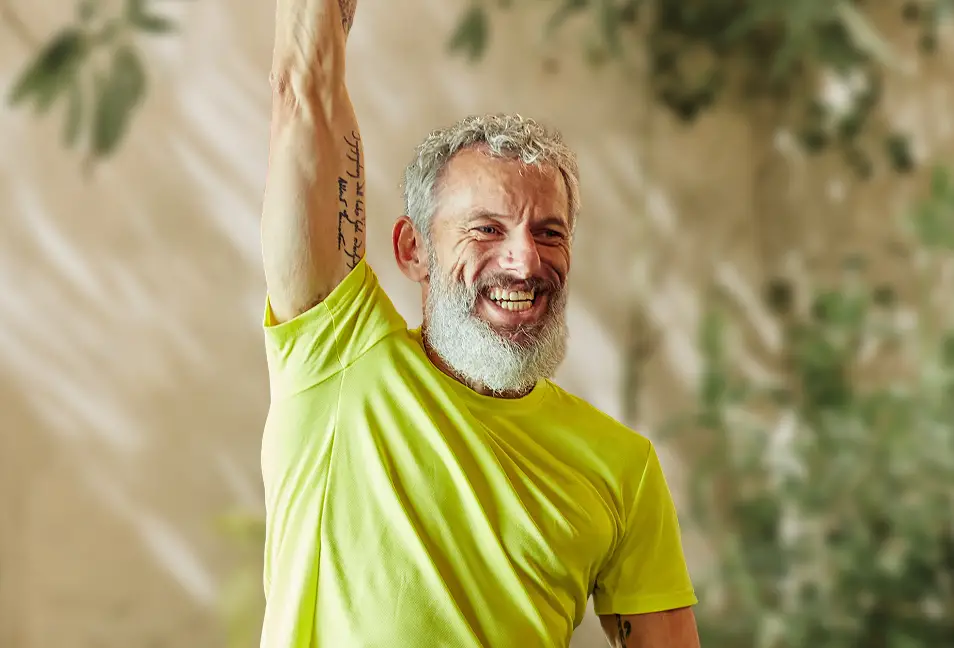 A smiling man stretching
