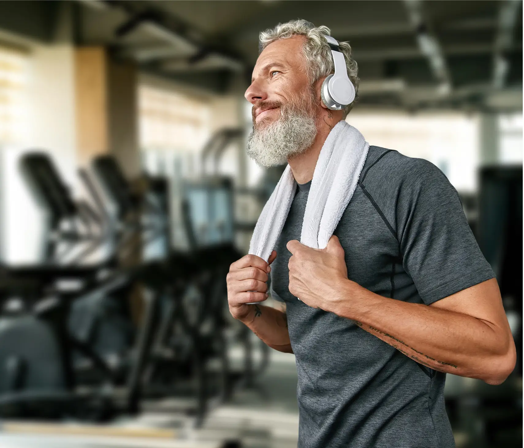 A man wearing headphone holding a towel around his neck
