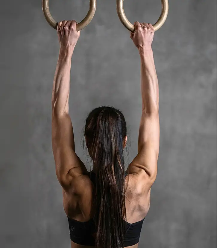 A woman hanging from rings