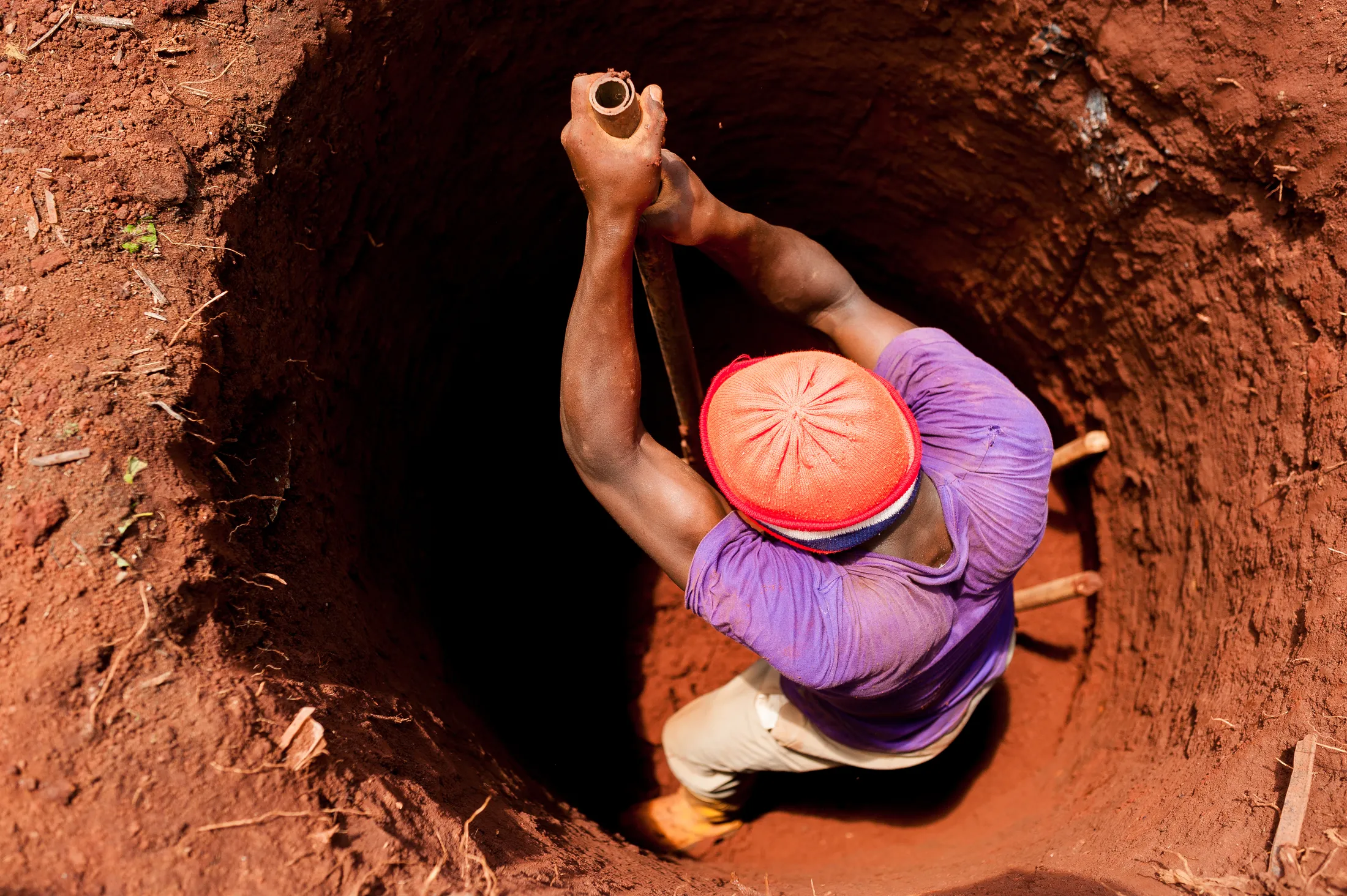 A man is being lowered into a well.