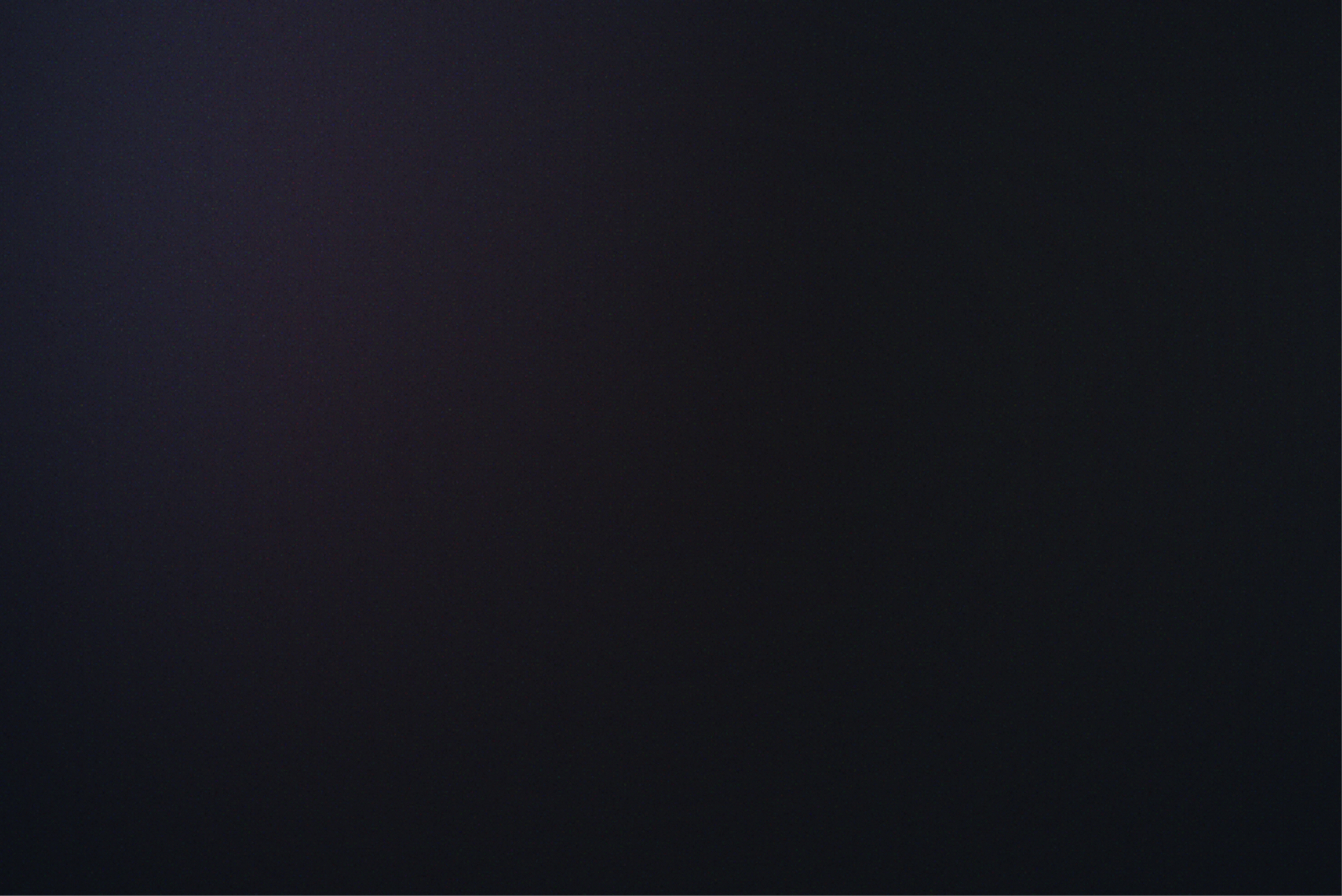 Dark black gradient background with subtle purple tint.