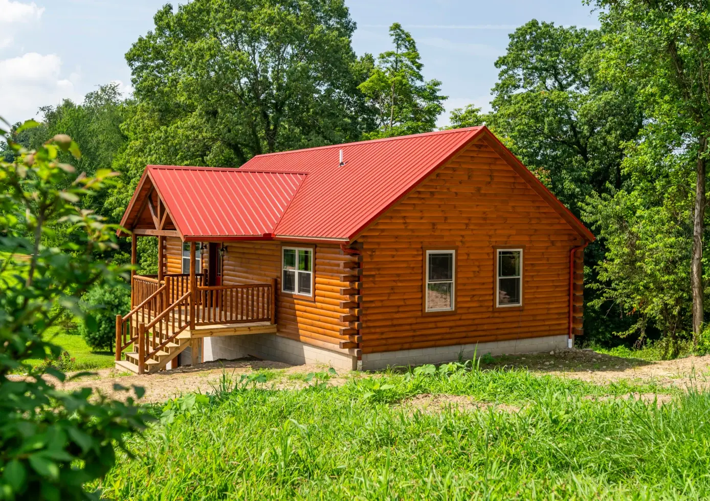 modular log cabin with red metal roof