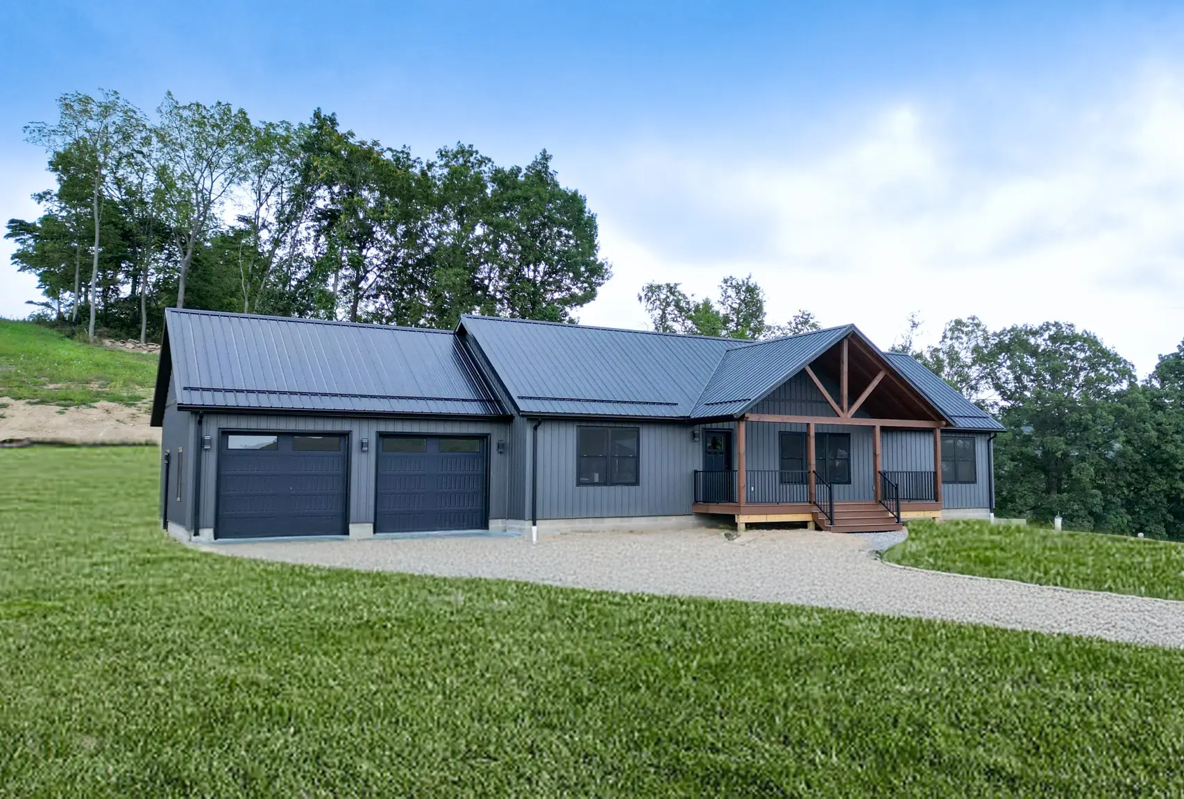 modular home with multi car garage and metal roof