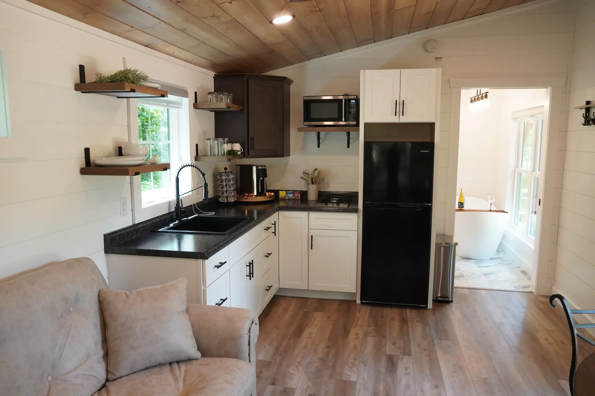 custom tiny home kitchen looking into bathroom