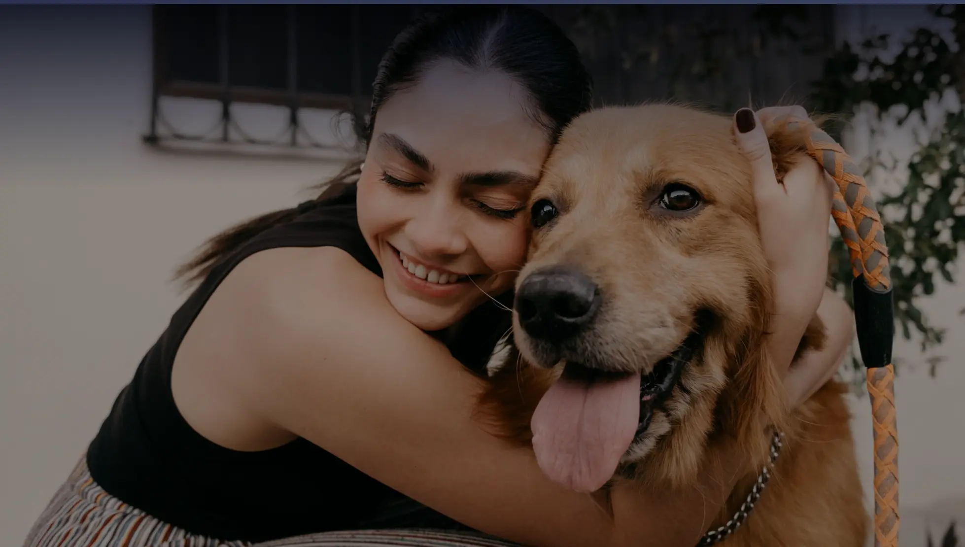 woman hugging happy dog