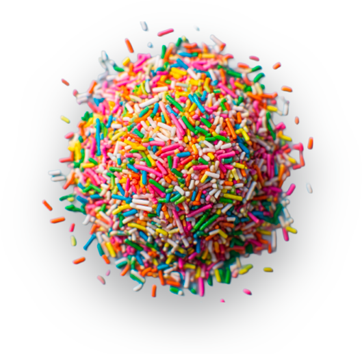 Close-up of a colorful pile of cylindrical rainbow sprinkles on a gray background.