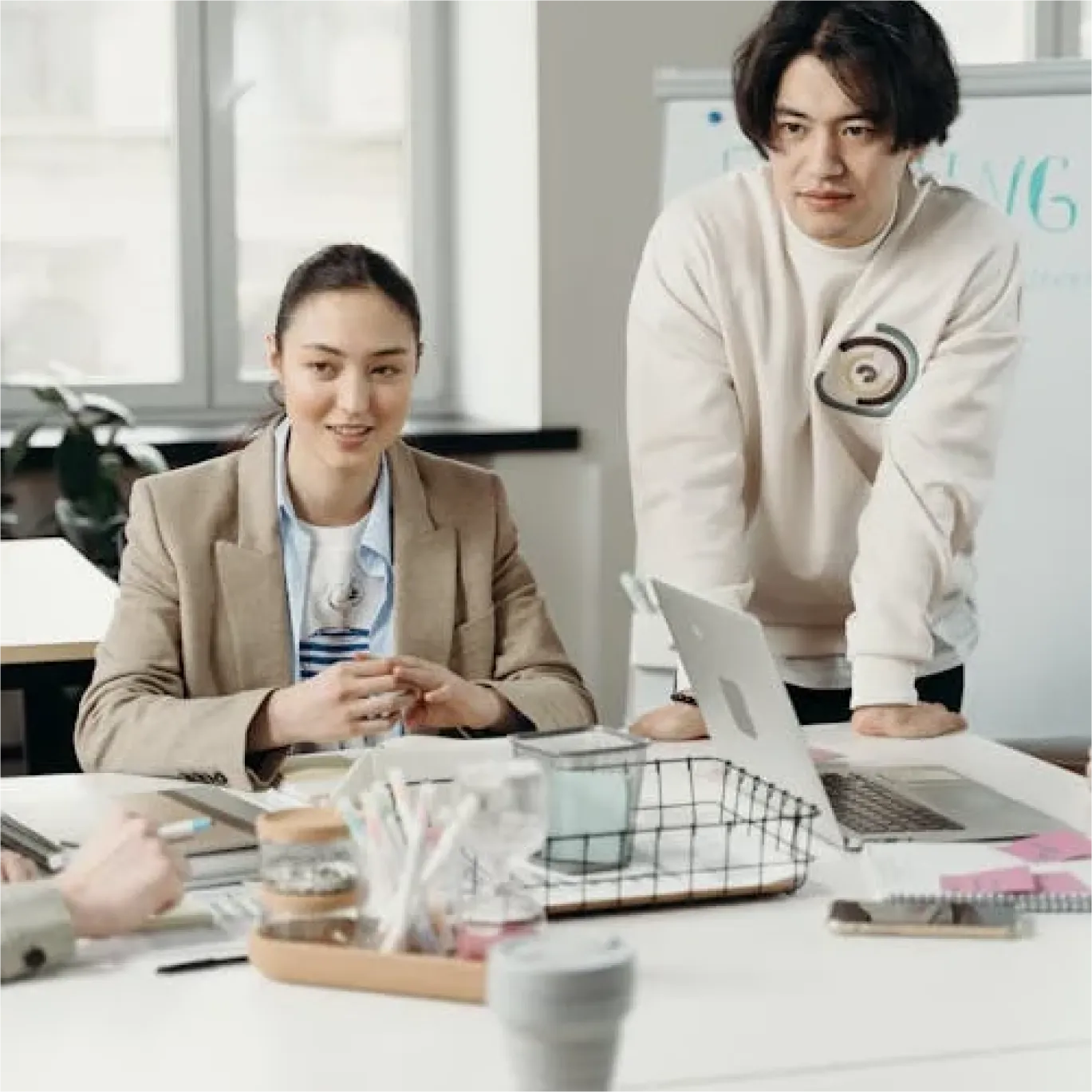 An image of two executives looking at someone who's talking to them.