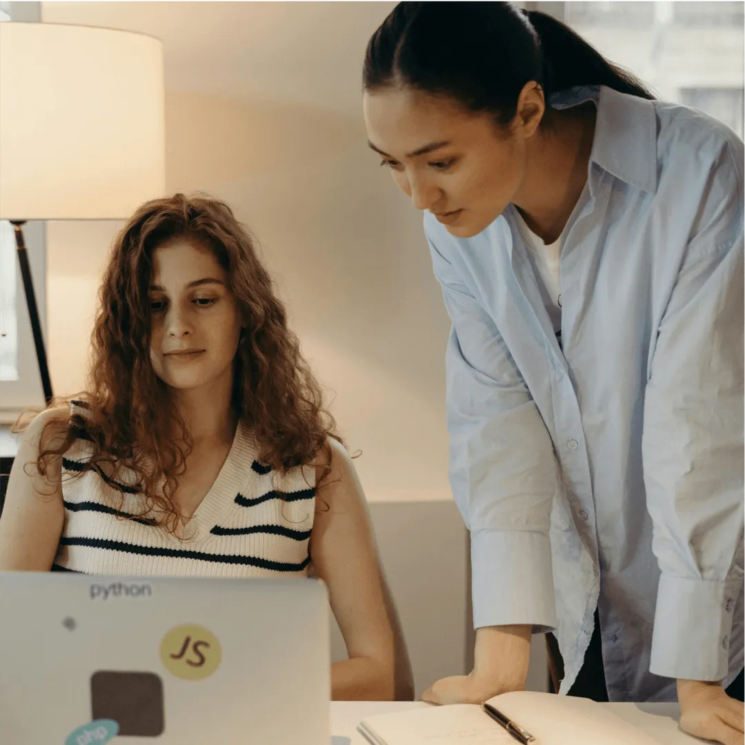 An image of two women looking at a tablet.