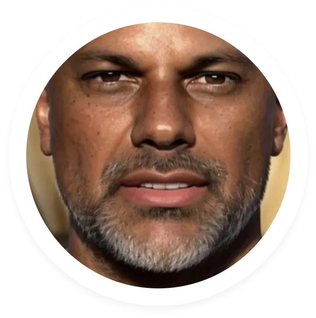 Close-up portrait of a middle-aged man with brown skin, short gray beard, and brown eyes.