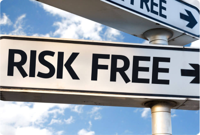 Street sign with the words RISK FREE and arrows pointing right against a blue sky with clouds.