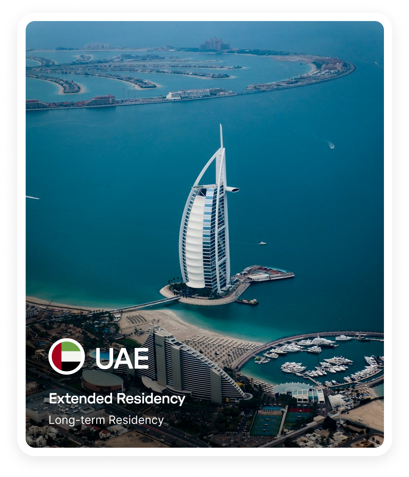Aerial view of the Burj Al Arab hotel on its own island with the Palm Jumeirah in the background in Dubai, UAE.