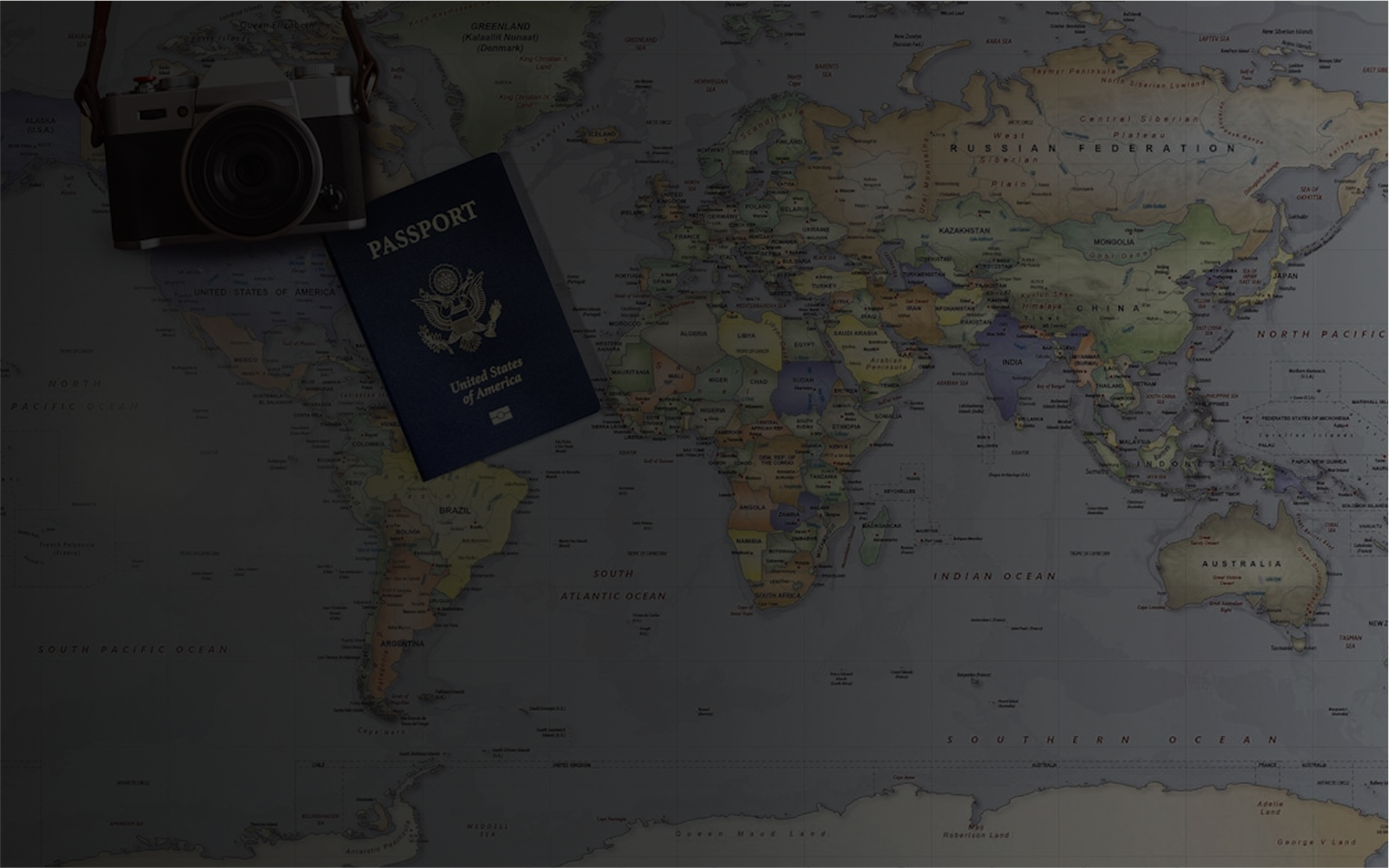 Flat lay of a vintage camera and a United States passport on a world map showing continents and countries.