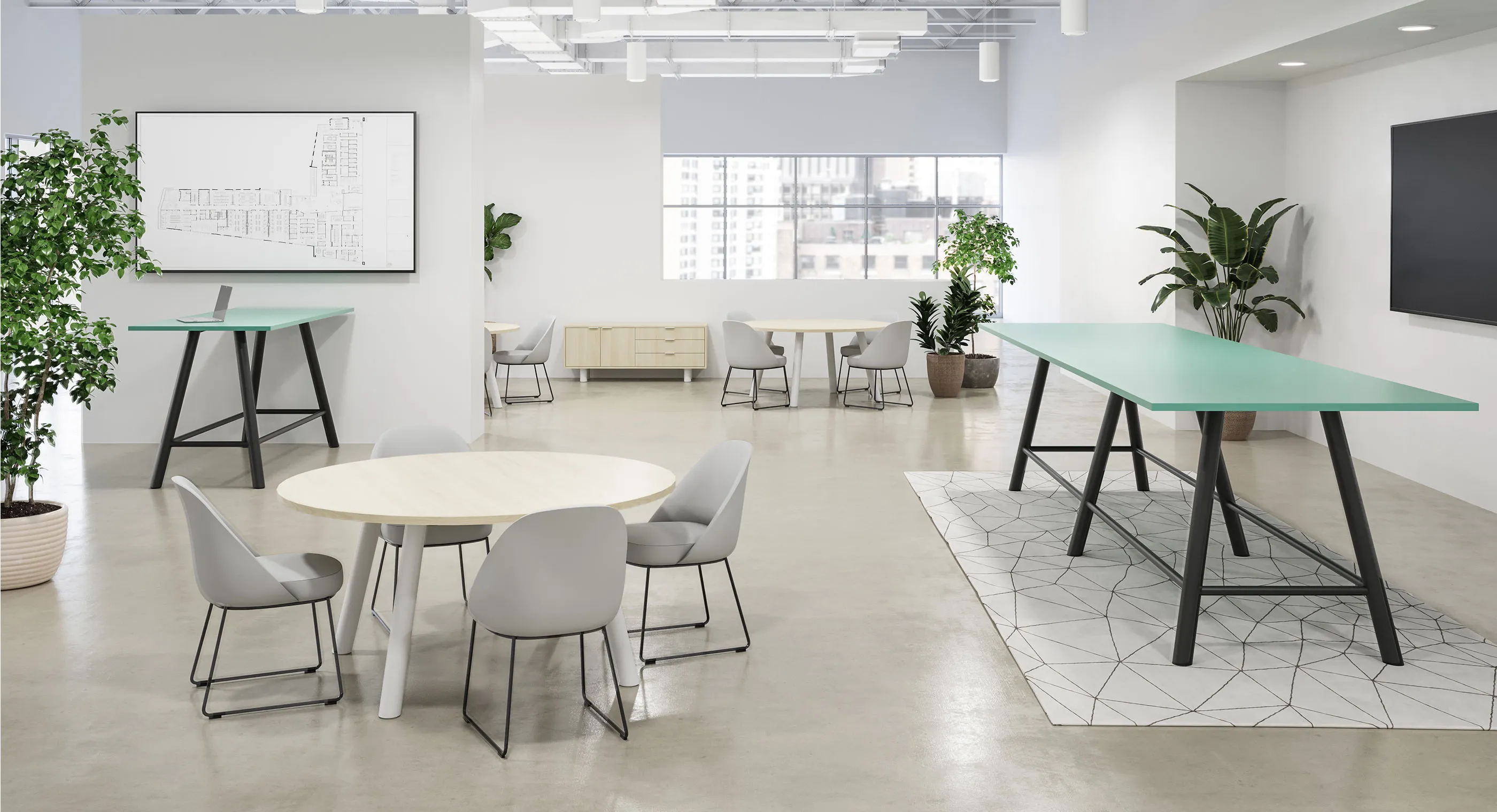 A white table with a green top in a room with a large window.