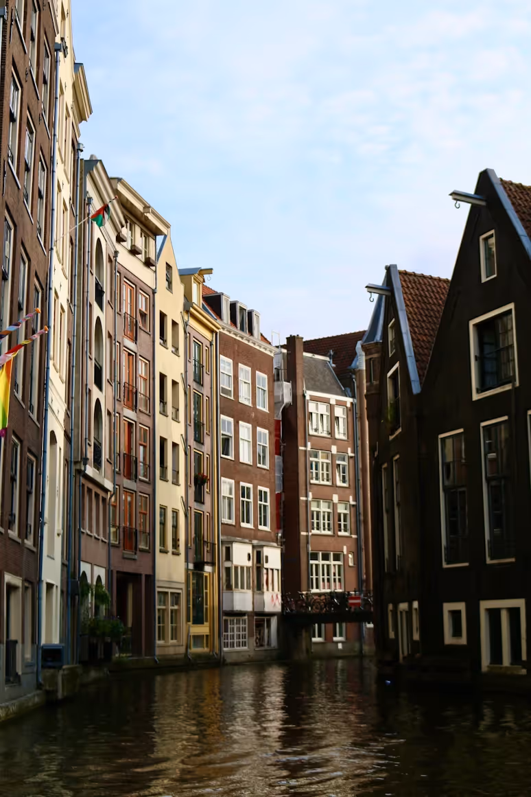 Feature article image of modern residential buildings under a clear blue sky.