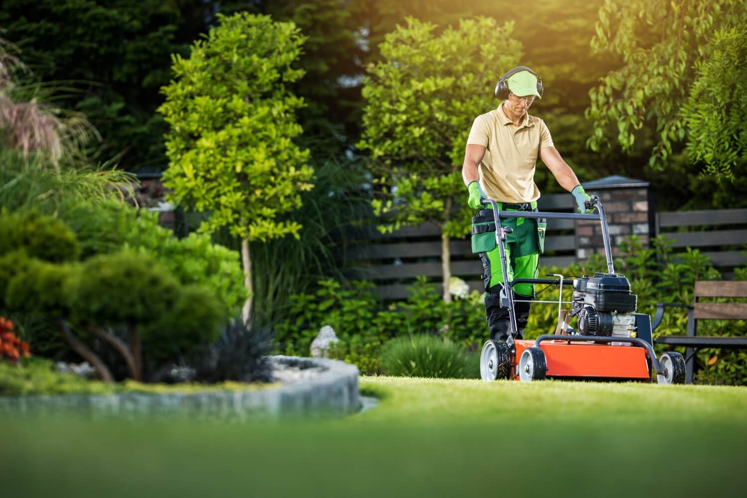 Man mowing a lawn with a push-mower