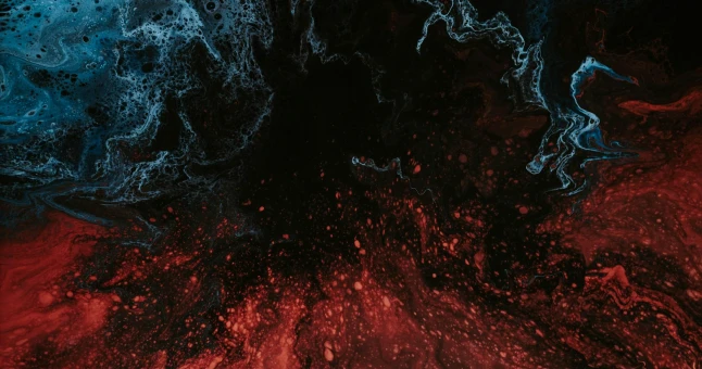 Abstract swirling liquid pattern with red, black, and blue colors blending and mixing.
