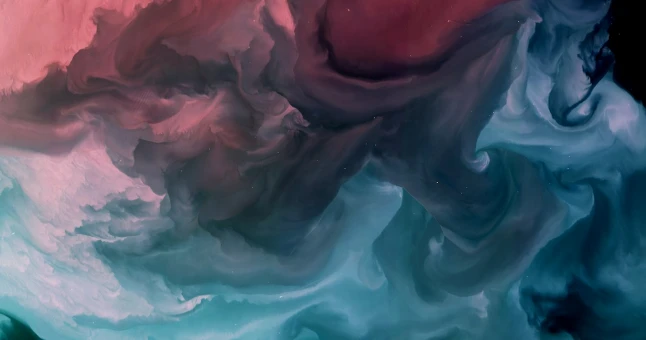 Abstract swirling clouds of pink, maroon, teal, and blue blending in a fluid, smoky pattern.