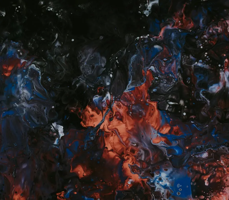 Abstract fluid art with swirling patterns of black, dark blue, red, and white colors.