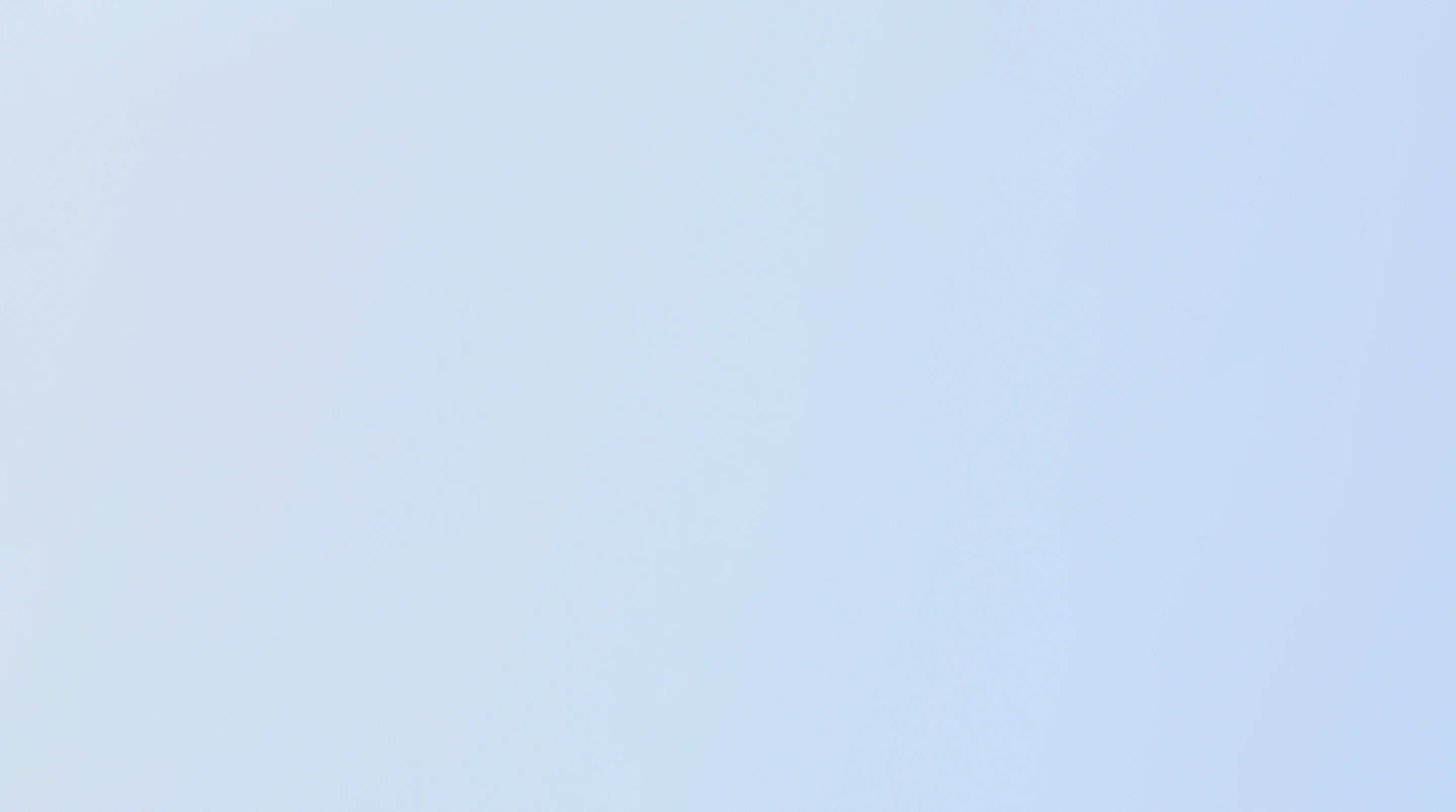 Empty rectangular sign mounted on a tall pole against a clear blue sky.