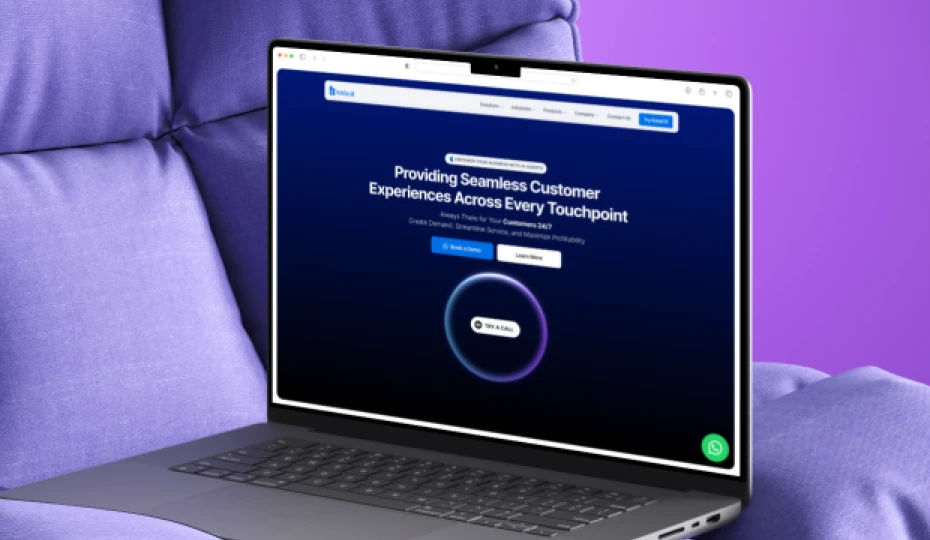 Laptop displaying a website homepage with a dark blue screen showing the text 'Providing Seamless Customer Experiences Across Every Touchpoint' on a purple fabric background.