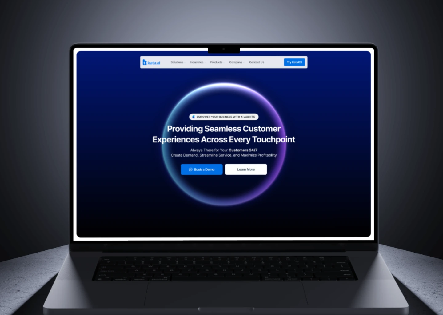 Laptop screen showing Kata.ai website homepage with headline about seamless customer experiences and buttons to book a demo or learn more.