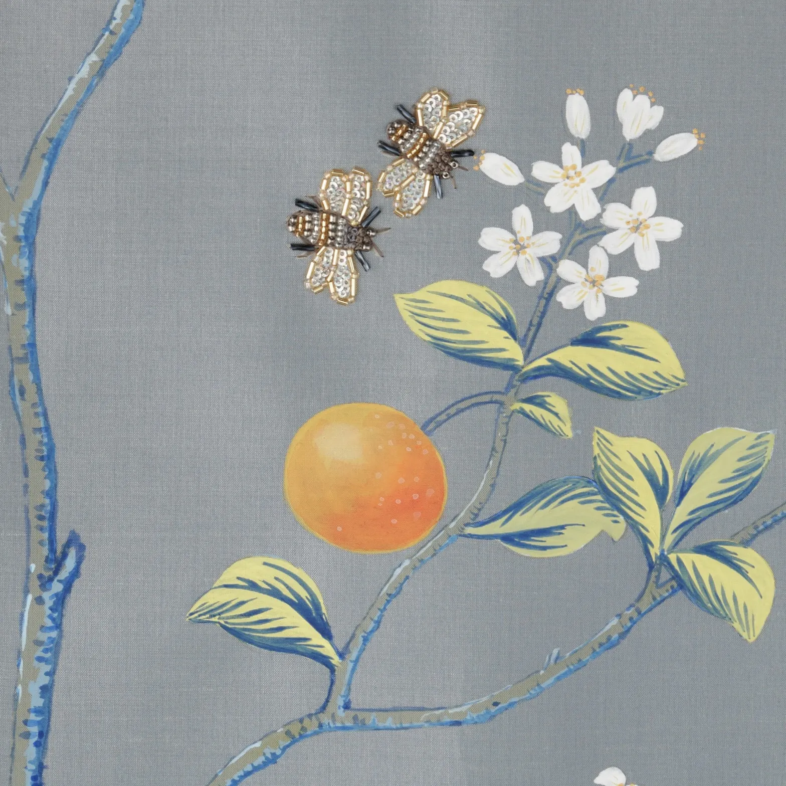 Detail of L'Orangerie Chinoiserie hand-painted wallcovering in Provence Blue showing gold-accented orange tree branches with beaded bees by Stang Design.