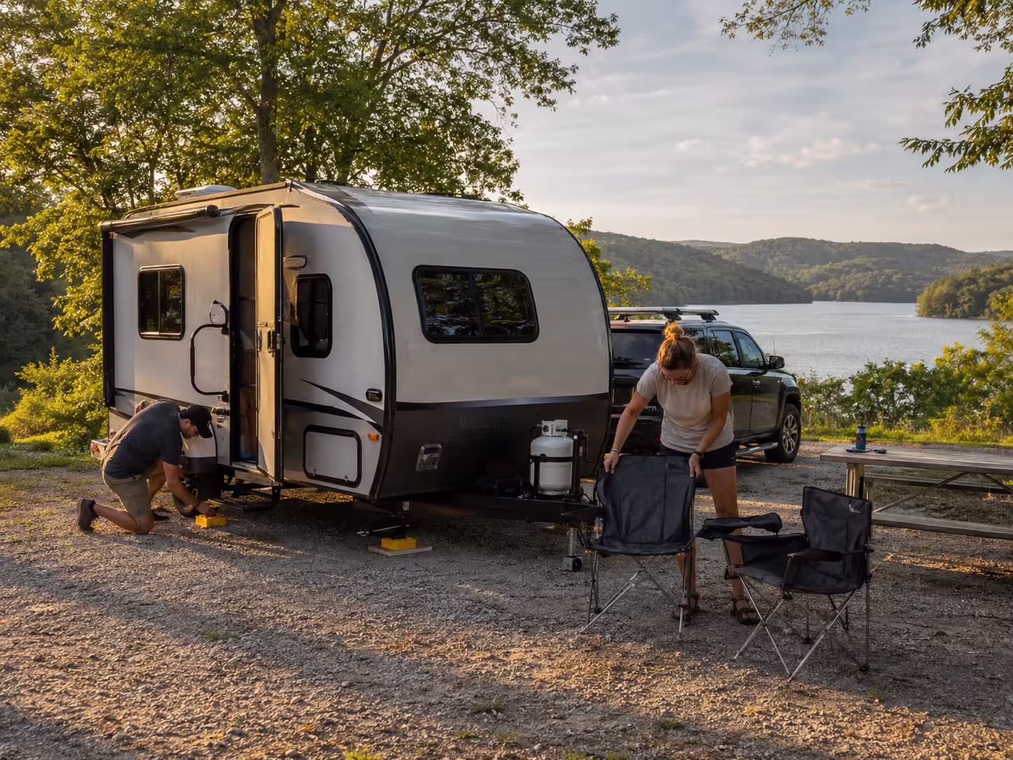 Couple with small RV at Ozarks lakeside campsite