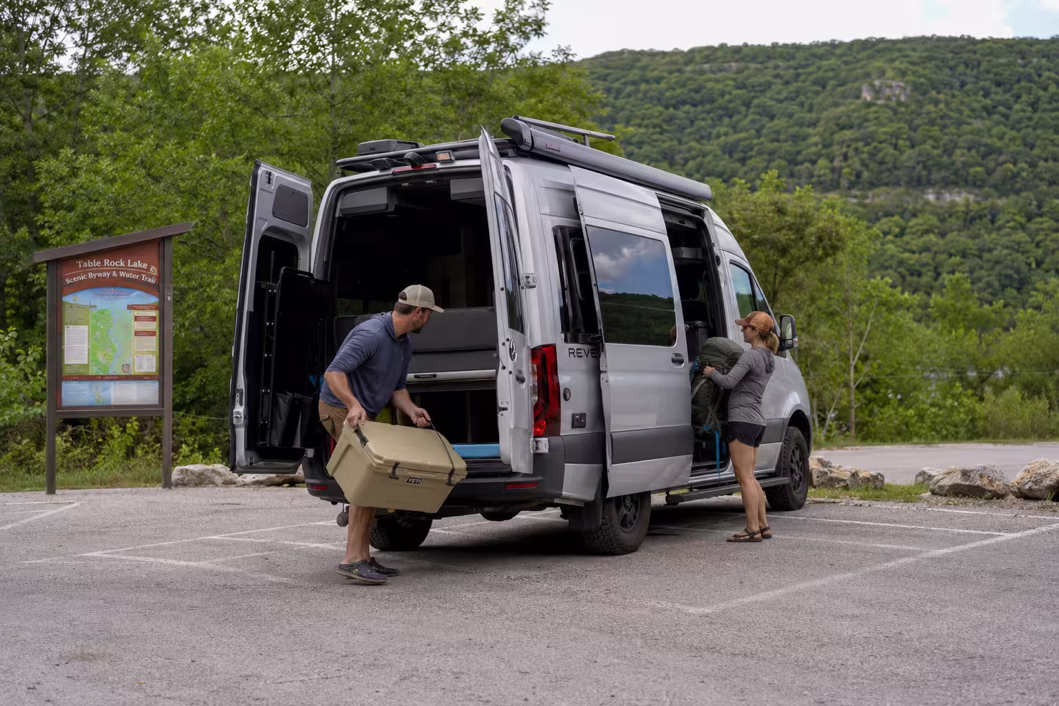 Couple packing a camper van at an Ozark trailhead near Springfield